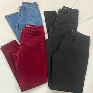 Four pairs of pants - blue and black Jeans, velvet red and slacks.